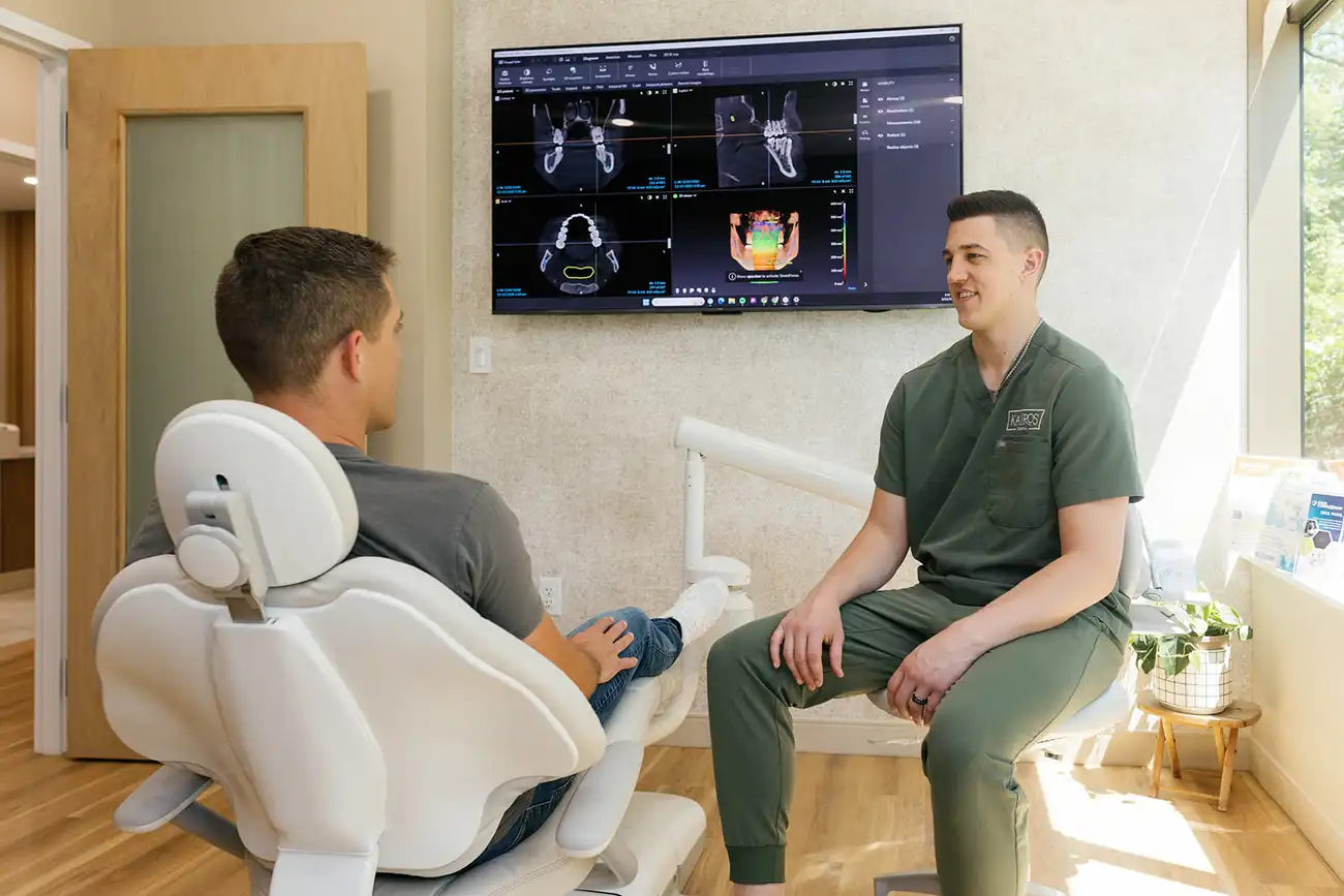 Dr. Koupal reviewing implant imaging with a patient at Kairos Holistic Dental