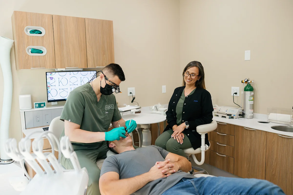 Dr. Tyler Koupal providing dental care with a Kairos team member assisting